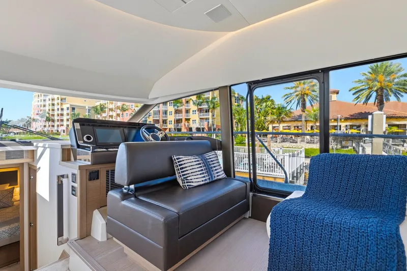Slide: The Image of Interior of 2022 Prestige 520 yacht with modern seating and large windows. - 42