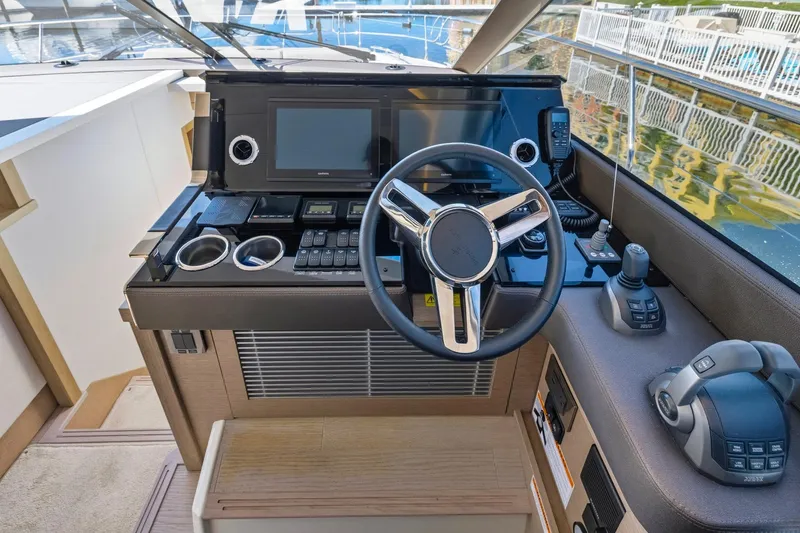 Slide: The Image of Cockpit of 2022 Prestige 520 yacht with modern steering and navigation controls. - 56