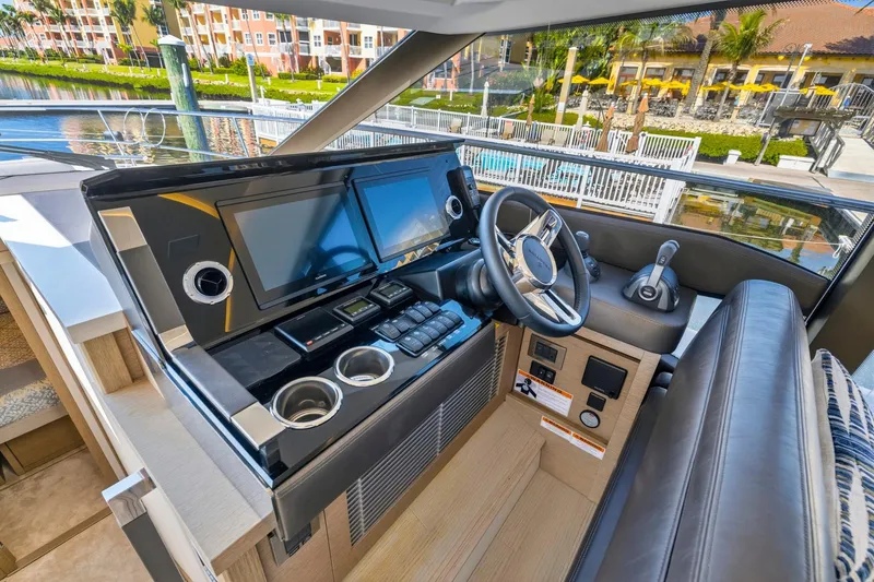 Slide: The Image of Modern helm station of 2022 Prestige 520 yacht with dual screens and luxurious seating. - 57