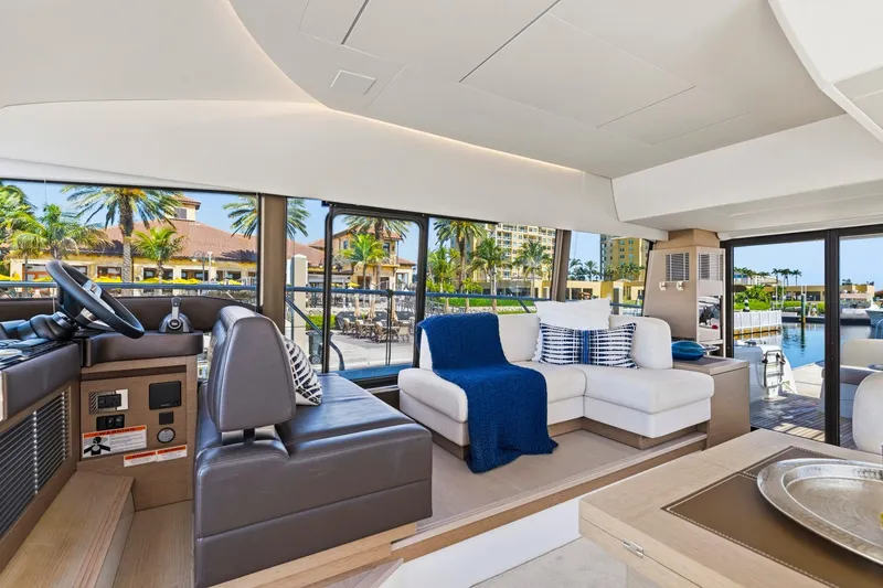 Slide: The Image of Luxurious interior of 2022 Prestige 520 yacht with modern seating and scenic marina view. - 58