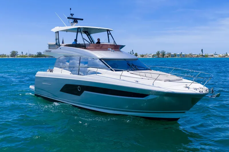 Slide: The Image of Luxury 2022 Prestige 520 yacht cruising on clear blue waters. - 6