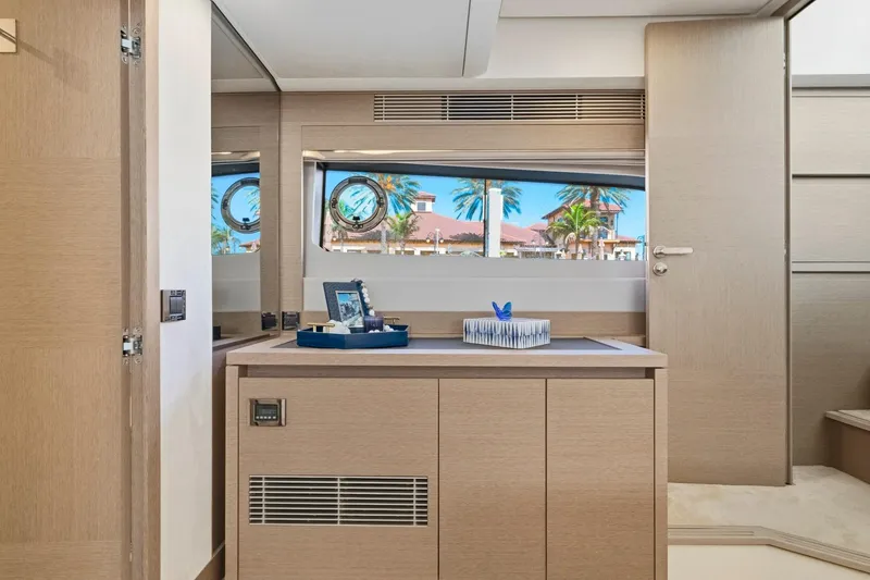 Slide: The Image of Luxurious interior of 2022 Prestige 520 yacht with elegant wood finish and scenic window view. - 62