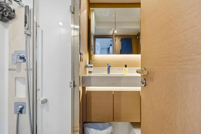 Slide: The Image of Modern bathroom interior on a 2022 Prestige 520 yacht, featuring sleek fixtures and wooden cabinetry. - 63