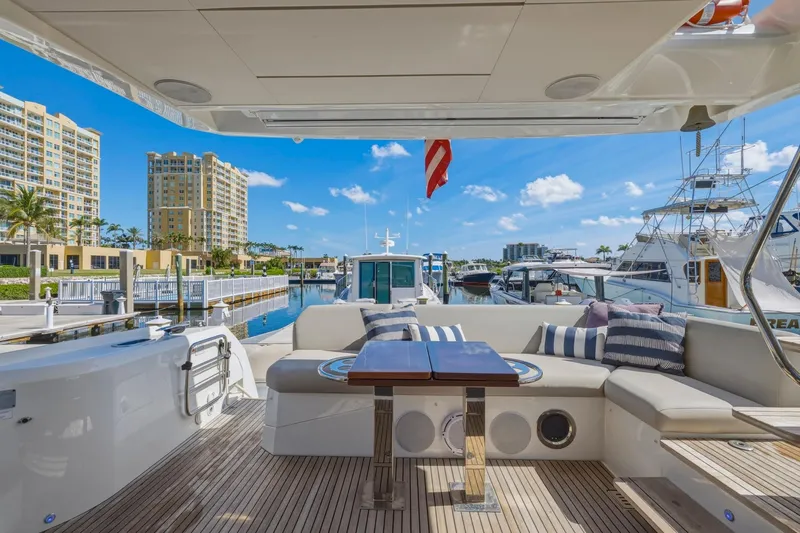 Slide: The Image of Luxurious 2022 Prestige 520 yacht interior with elegant seating, docked in a scenic marina. - 67