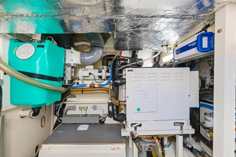 Slide: The Image of Engine room of a 2022 Prestige 520 yacht with various mechanical components. - 77