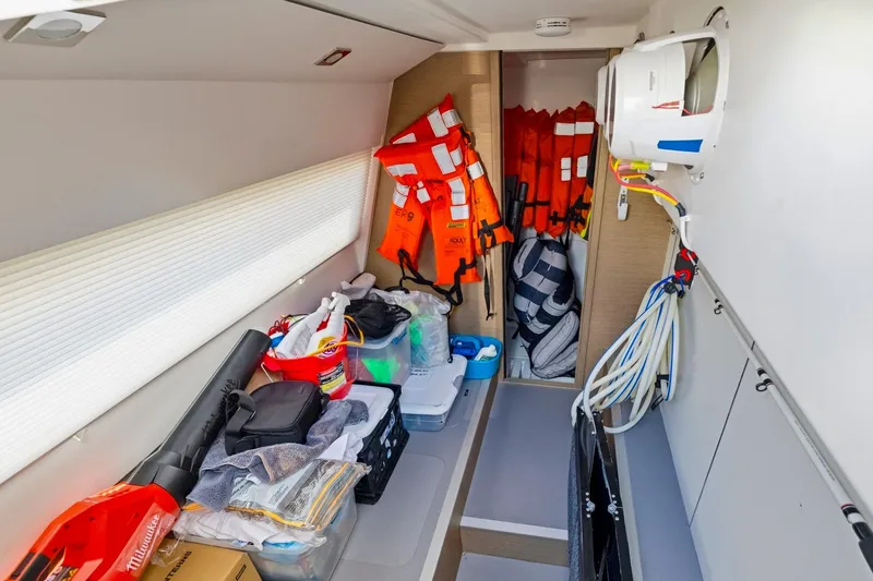 Slide: The Image of Storage area in a 2022 Prestige 520 yacht with life jackets and equipment. - 78