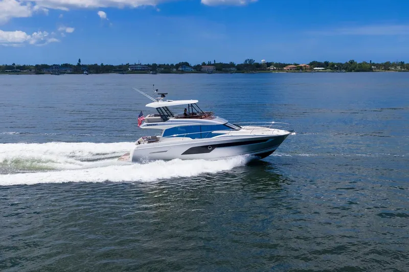 Slide: The Image of 2022 Prestige 520 yacht cruising on a sunny day, showcasing sleek design and performance. - 86