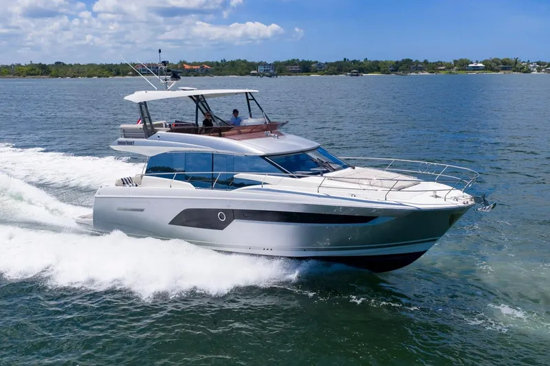 Slide: The Image of Luxury 2022 Prestige 520 yacht cruising on open water under a clear sky. - 94