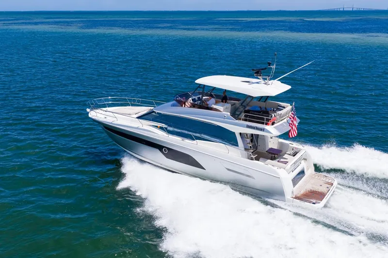 Slide: The Image of 2022 Prestige 520 yacht cruising on open blue ocean waters. - 95