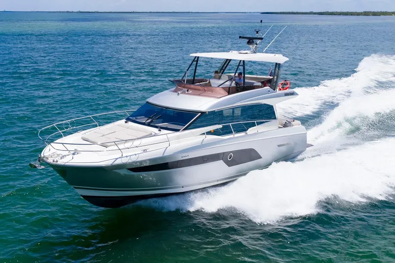 Slide: The Image of 2022 Prestige 520 yacht cruising on open water, showcasing sleek design and luxury features. - 97