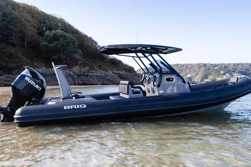 Slide: The Image of 2026 Brig Eagle 8 boat with Suzuki engine on a scenic shoreline. - 8