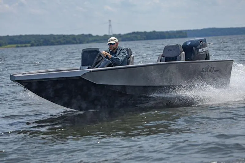 Slide: The Image of Man driving Excel EX 203 boat on a lake, 2026 model, with Suzuki engine. - 4
