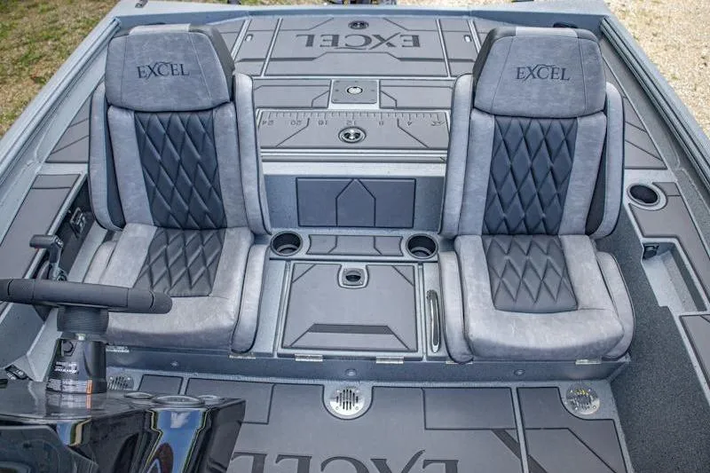 Slide: The Image of 2026 Excel EX 203 boat interior with dual cushioned seats and storage compartments. - 6