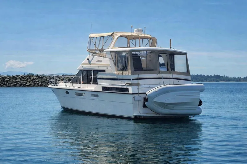 Slide: The Image of 1989 TransWorld 39 Flushdeck Motor Yacht on calm water, clear sky background. - 1