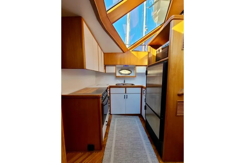 Slide: The Image of Interior of 1989 TransWorld 39 Flushdeck Motor Yacht kitchen with wood cabinetry and skylight. - 10
