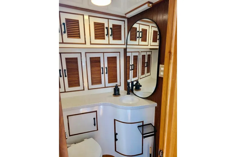 Slide: The Image of Elegant bathroom on 1989 TransWorld 39 Flushdeck Motor Yacht with wood accents and oval mirror. - 13