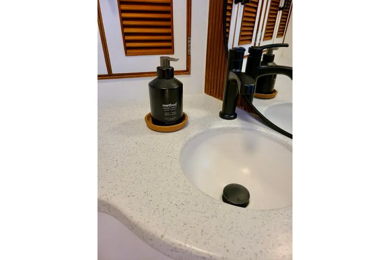 Slide: The Image of Bathroom sink with black faucet and soap dispenser on TransWorld 39 Flushdeck Motor Yacht, 1989. - 14