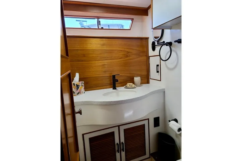 Slide: The Image of Elegant bathroom in 1989 TransWorld 39 Flushdeck Motor Yacht with wood accents and modern fixtures. - 16