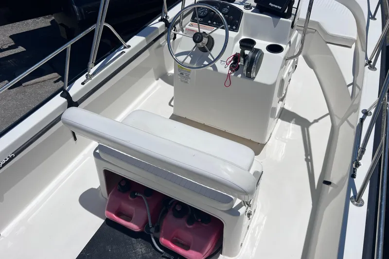 Slide: The Image of 2017 Boston Whaler 170 Montauk boat interior with steering console and seating. - 11