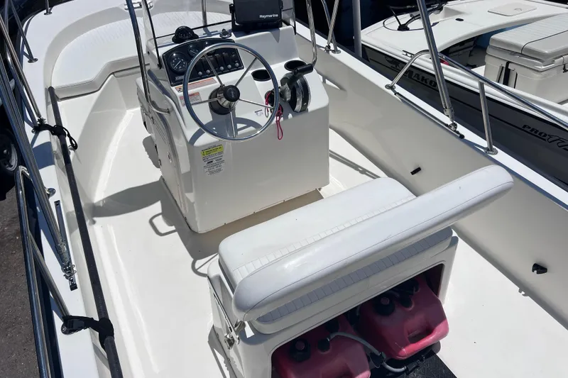 Slide: The Image of 2017 Boston Whaler 170 Montauk boat interior with steering console and seating. - 12