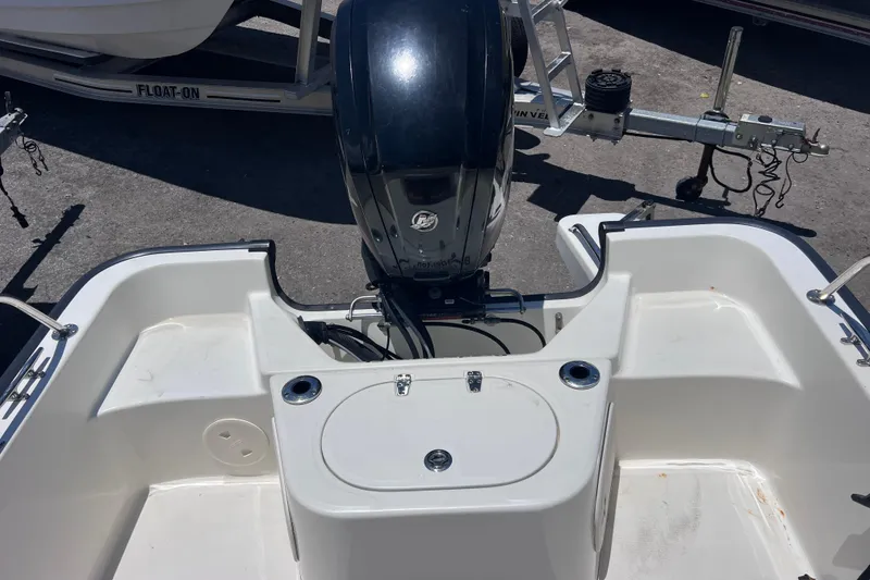 Slide: The Image of 2017 Boston Whaler 170 Montauk boat stern with motor and trailer. - 13