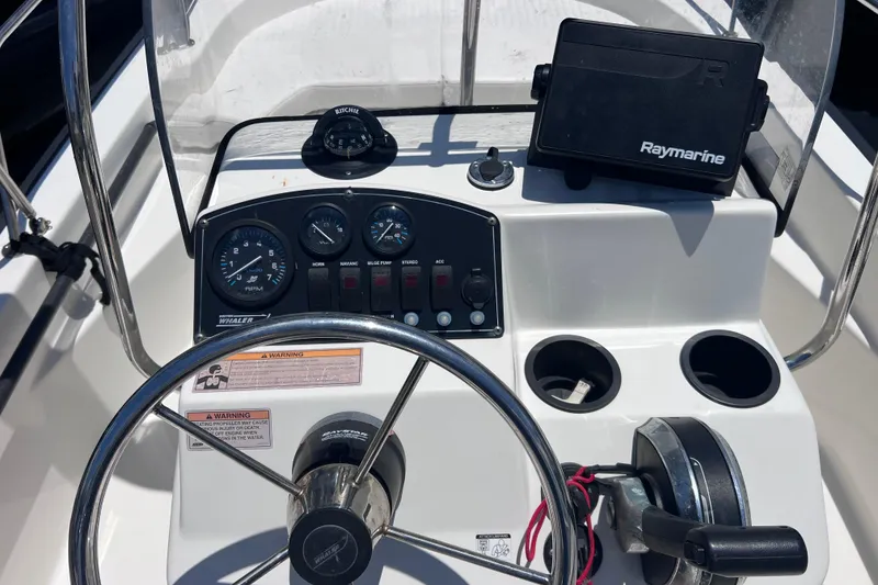 Slide: The Image of Boston Whaler 170 Montauk 2017 dashboard with steering wheel and Raymarine navigation system. - 18