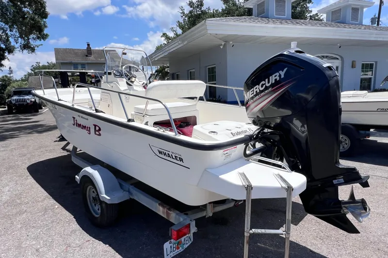 Slide: The Image of 2017 Boston Whaler 170 Montauk boat with Mercury engine on trailer. - 2