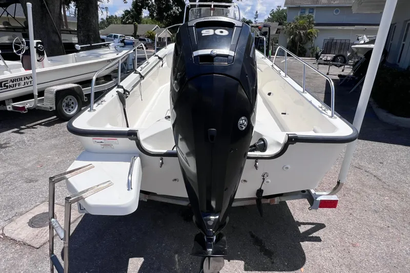 Slide: The Image of 2017 Boston Whaler 170 Montauk boat with outboard motor, parked on a trailer. - 3