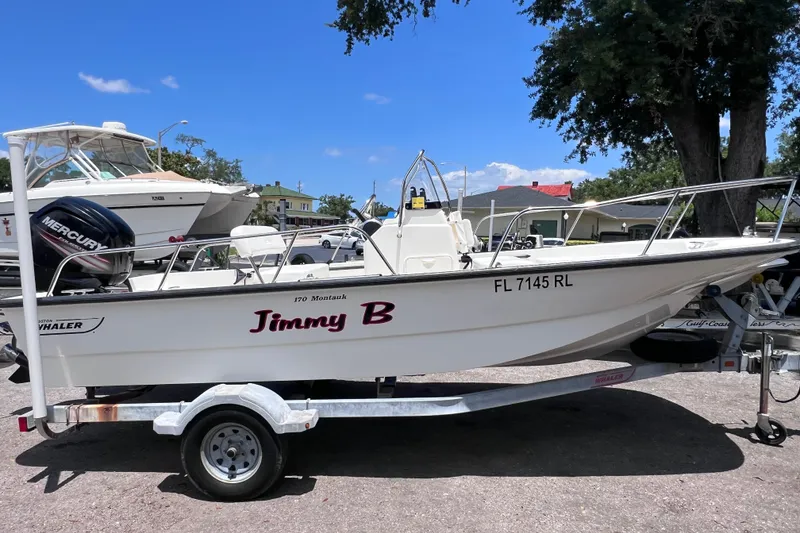 Slide: The Image of 2017 Boston Whaler 170 Montauk boat on trailer, labeled "Jimmy B," with Mercury engine. - 5