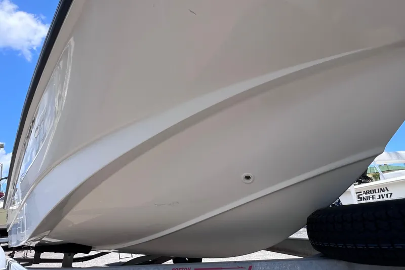Slide: The Image of 2017 Boston Whaler 170 Montauk boat hull on trailer, under clear blue sky. - 7