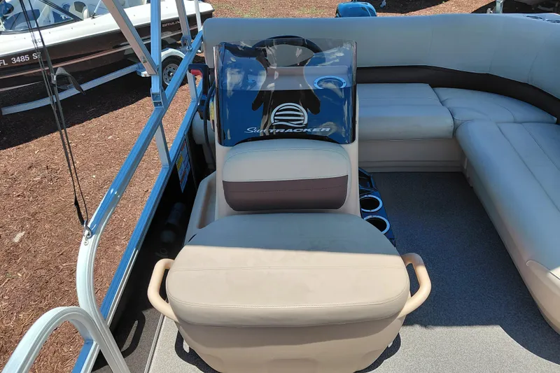 Slide: The Image of 2019 Sun Tracker Bass Buggy 16 DLX pontoon boat interior with seating and steering console. - 17