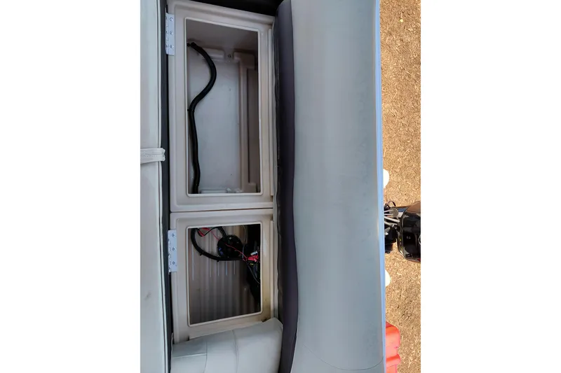 Slide: The Image of 2019 Sun Tracker Bass Buggy 16 DLX storage compartments with wiring visible. - 21