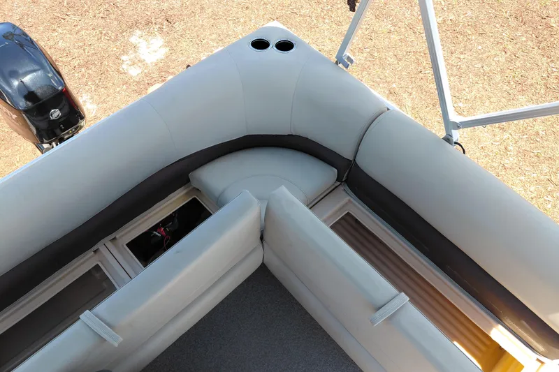 Slide: The Image of 2019 Sun Tracker Bass Buggy 16 DLX pontoon boat interior with cushioned seating and storage compartments. - 23