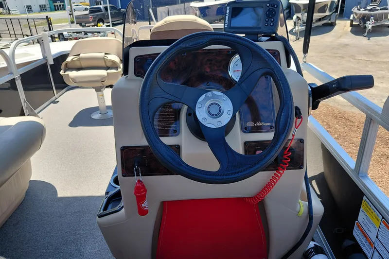 Slide: The Image of 2019 Sun Tracker Bass Buggy 16 DLX steering console with navigation equipment and seating. - 26