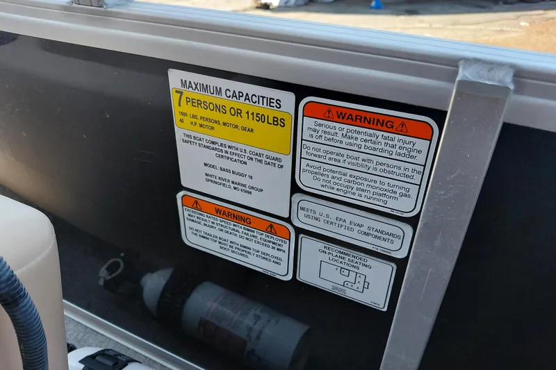 Slide: The Image of 2019 Sun Tracker Bass Buggy 16 DLX capacity and safety warning labels on boat interior. - 27