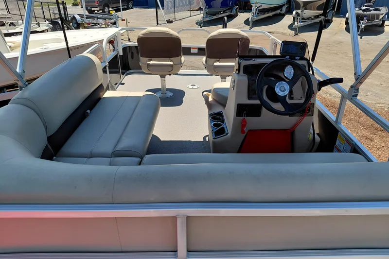 Slide: The Image of 2019 Sun Tracker Bass Buggy 16 DLX pontoon boat interior with seating and steering console. - 31