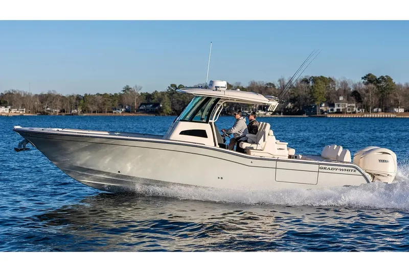 The Image of Manufacturer Provided Image: 2026 Grady-White 321 Coastal Explorer boat cruising on a serene lake. - 0