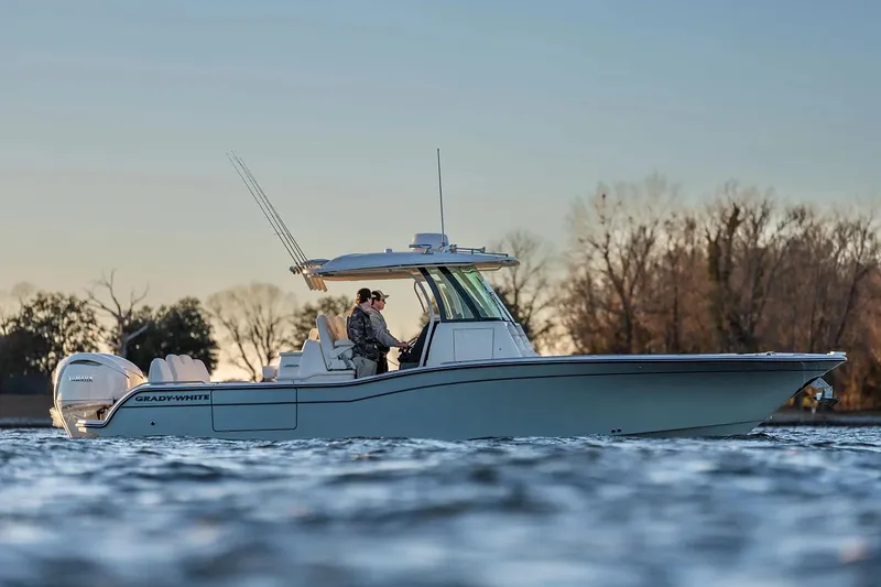 Slide: The Image of Manufacturer Provided Image: 2026 Grady-White 321 Coastal Explorer boat on water, trees in background. - 1