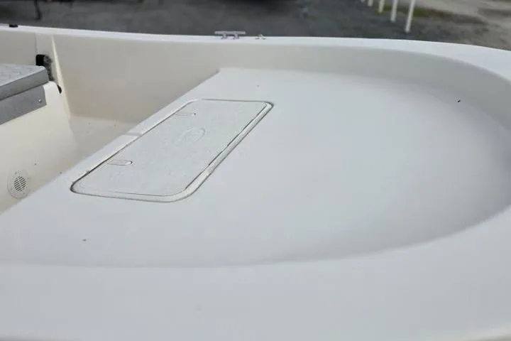 Slide: The Image of 2025 Carolina Skiff E18 JVX CC boat deck with storage compartment. - 12