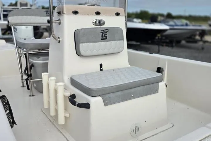 Slide: The Image of 2025 Carolina Skiff E18 JVX CC boat interior with cushioned seating and rod holders. - 13