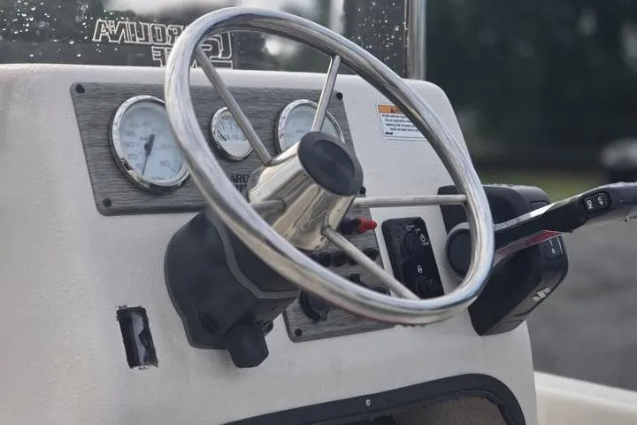 Slide: The Image of Steering console of 2025 Carolina Skiff E18 JVX CC boat with gauges and controls. - 19