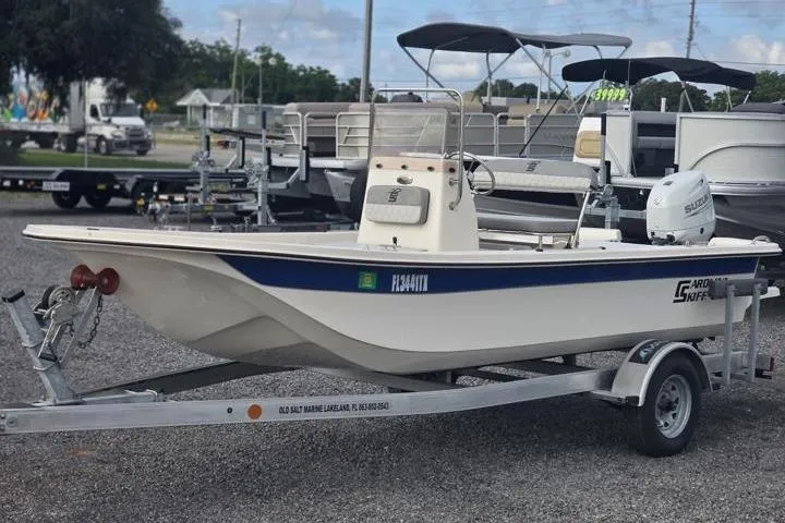 The Image of 2025 Carolina Skiff E18 JVX CC boat on trailer, displayed outdoors. - 4