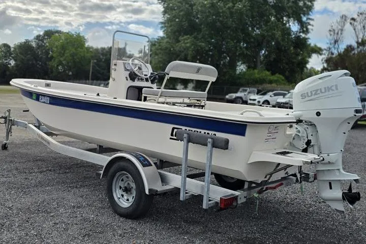 Slide: The Image of 2025 Carolina Skiff E18 JVX CC boat on trailer with Suzuki outboard motor. - 6