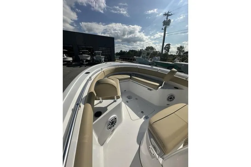 Slide: The Image of 2026 Sportsman Heritage 231 Center Console boat with beige seating under a sunny sky. - 12