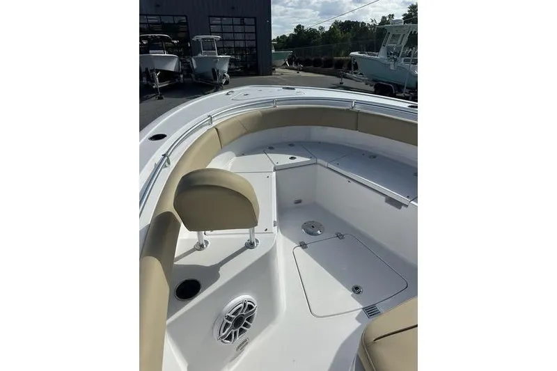 Slide: The Image of 2026 Sportsman Heritage 231 Center Console boat interior with cushioned seating and storage compartments. - 15