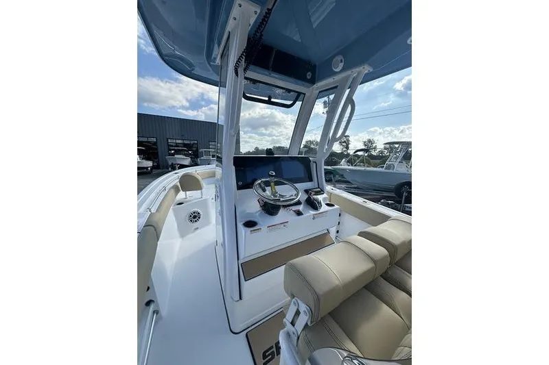 Slide: The Image of 2026 Sportsman Heritage 231 Center Console boat interior with steering wheel and seating. - 16
