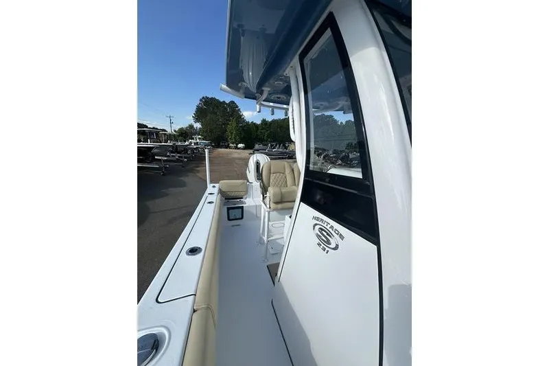 Slide: The Image of 2026 Sportsman Heritage 231 Center Console boat, side view with seating and console details. - 17