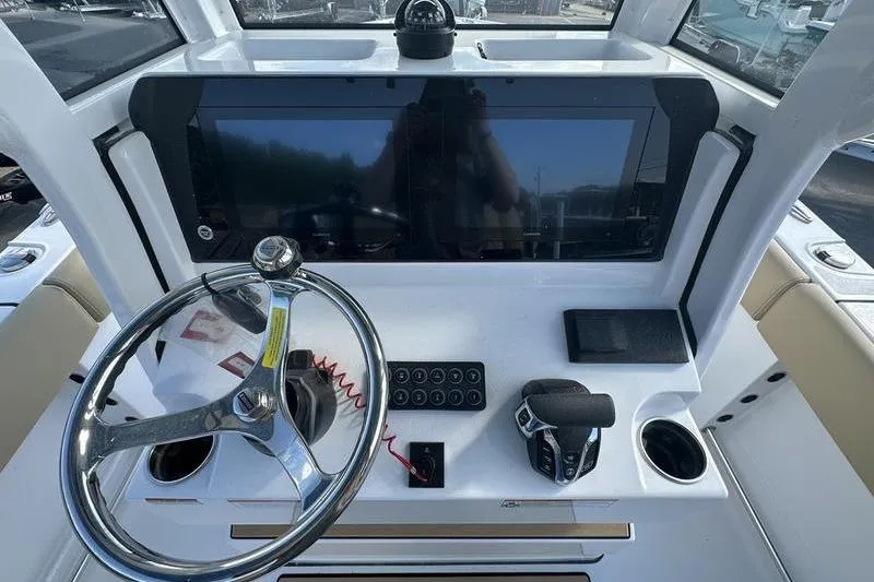 Slide: The Image of 2026 Sportsman Heritage 231 Center Console dashboard with steering wheel and control panel. - 18