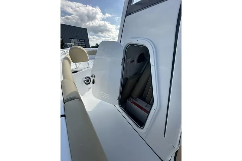 Slide: The Image of 2026 Sportsman Heritage 231 Center Console boat interior with open storage compartment. - 19