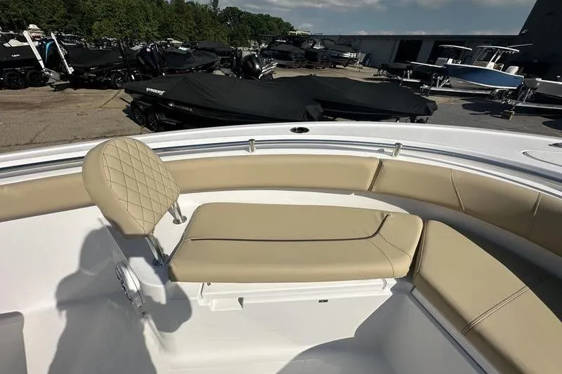 Slide: The Image of 2026 Sportsman Heritage 231 Center Console boat with beige seating in a marina. - 21